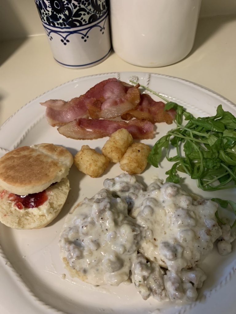 Plate of low fodmap biscuits with sausage gravy or butter and jam